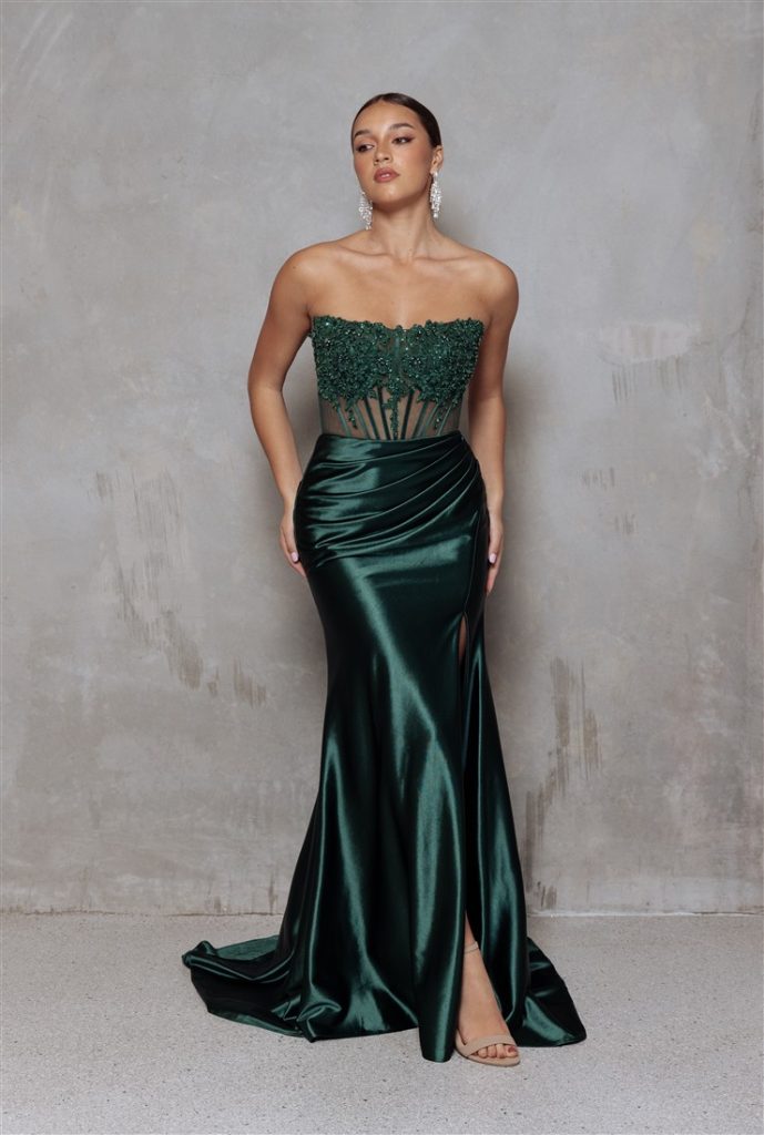Fitted emerald green prom dress with lace and beaded bodice and shear detail